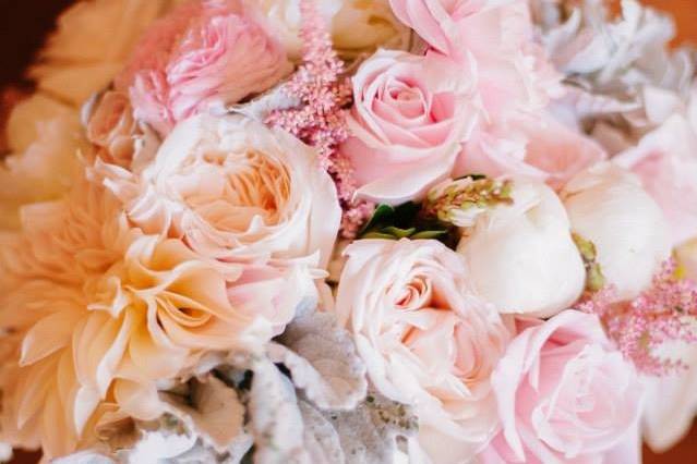Gorgeous blush and white bridal bouquet designed with dahlias, garden roses, peonies, roses, alstibe and dusty miller.