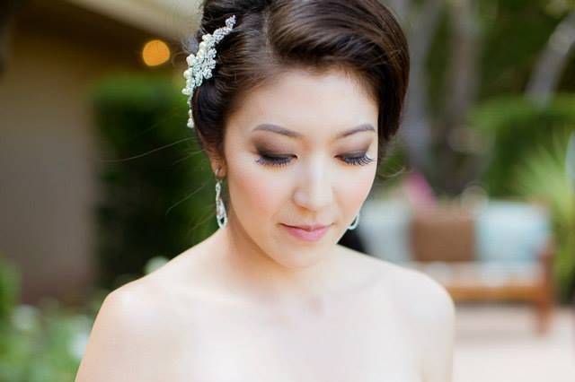 Bridesmaid bouquet designed with white hydrangea, peach roses, pink garden spray roses, white hypericum and dusty miller.