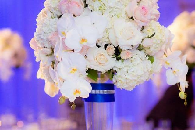 Elegant centerpiece designed with white hydrangea, blush roses and white phalaenopsis orchids.