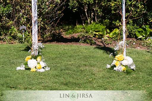 Playful and bright bridal bouquet designed with white garden roses, white and yellow ranunculus, yellow billy balls, yellow spray roses, succulents and dusty miller, perfect for this garden wedding.