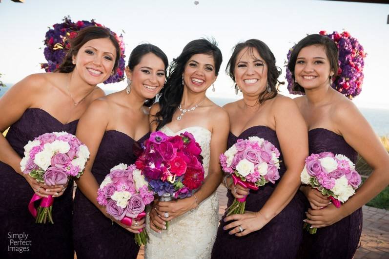 Our beautiful bride with her lovely bridesmaids.  Bridal bouquet designed with fuchsia garden roses, dahlias, anemones, purple hydrangea and purple dendrobium orchids.  Bridesmaids designed with white and lavender roses with fuchsia stock.