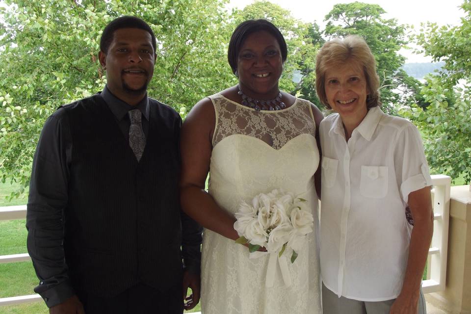Pastor Deb Helton with the bride and groom