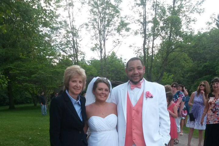Pastor Deb Helton with the bride and groom