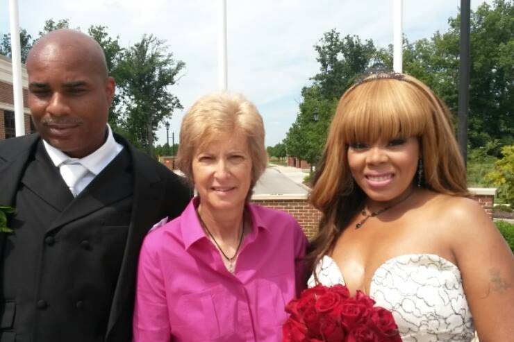 Pastor Deb Helton with the bride and groom