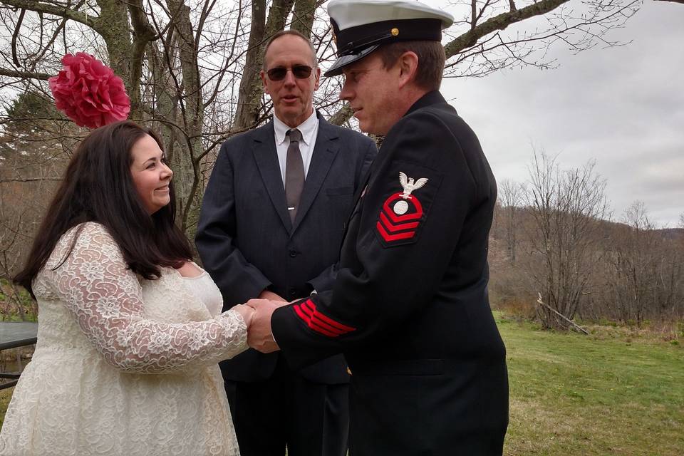 Newlywed couple with the officiant