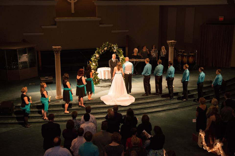 Custom bridal gown, groom's vest, men's ties, and maid-of-honor dress