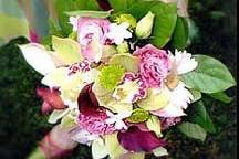 Contemporary, round, hand-tied, fresh floral bridesmaid's bouquet featuring calla lilies, kermit mums, gerberas, lisanthus, and stephanotis, designed by Something Floral.