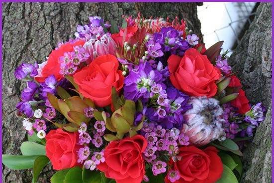 Contemporary, round, hand-tied, fresh floral bridesmaid's bouquet featuring calla lilies, kermit mums, gerberas, lisanthus, and stephanotis, designed by Something Floral.