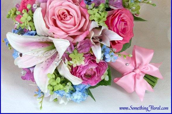 Formal cascade bouquet of high quality, artificial / silk lilies, roses, and zinnias, designed by Something Floral.