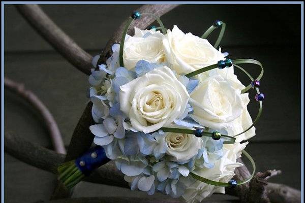 Contemporary groom's boutonniere in purple and lime green, designed by Something Floral.