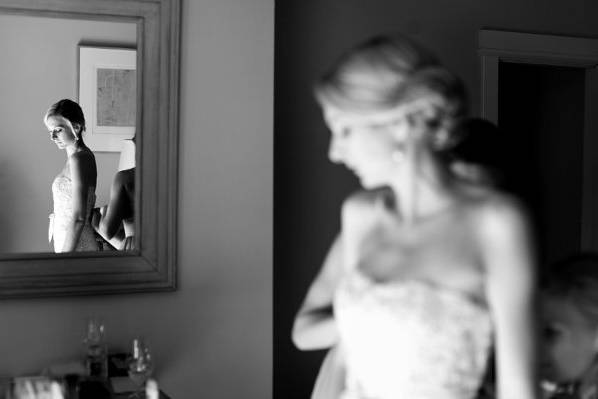Siobhan getting ready in her dress by monique lhuillier