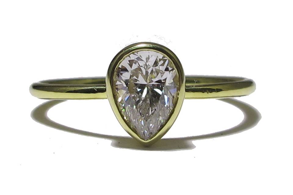 This yellow gold ring features a bezel set pear diamond, approximately .75 carats. Simple and gorgeous.
