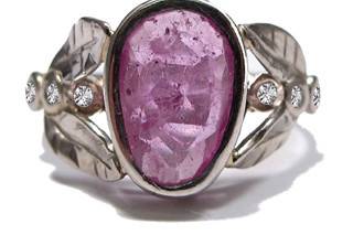 This organic leafy ring features a natural pink sapphire, weighing over 1 carat, with three diamonds on each side. One of a kind.