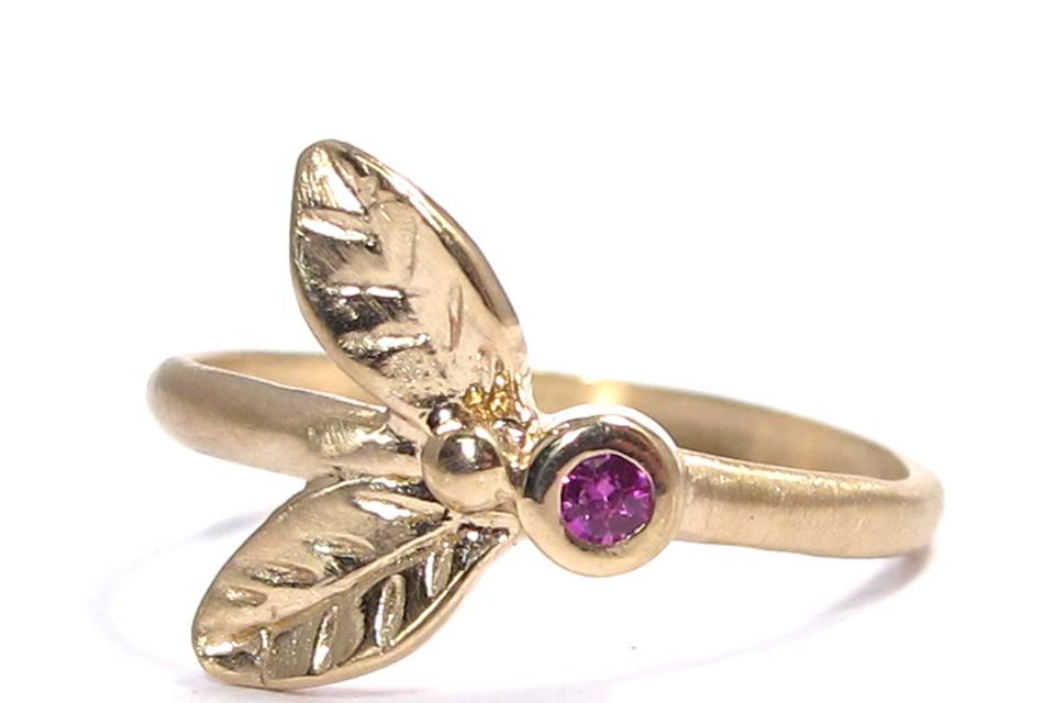 This organic leafy yellow gold ring features a bezel-set  .02 carat ruby.