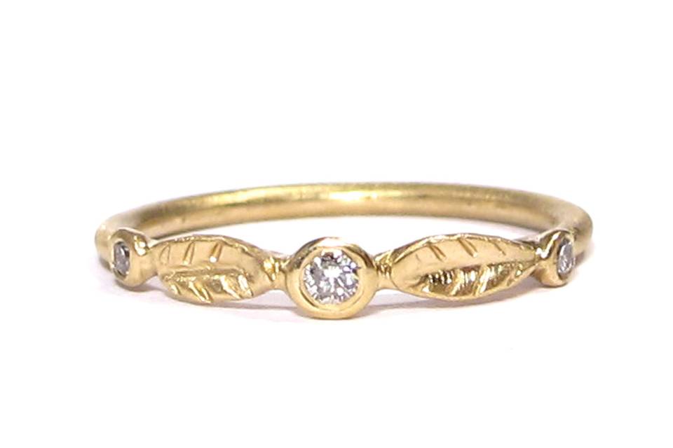 This leafy organic wedding band features three diamonds and comes in both yellow and white gold.