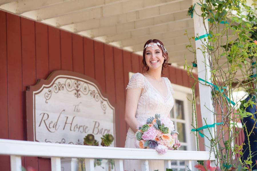 Bride at red horse barn