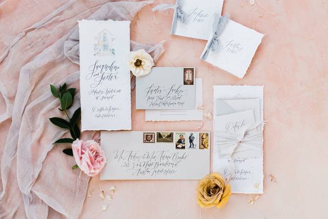 A gorgeous flat lay, featuring Prairie Letter Shop's hand lettered invitation suite and hand painted venue.