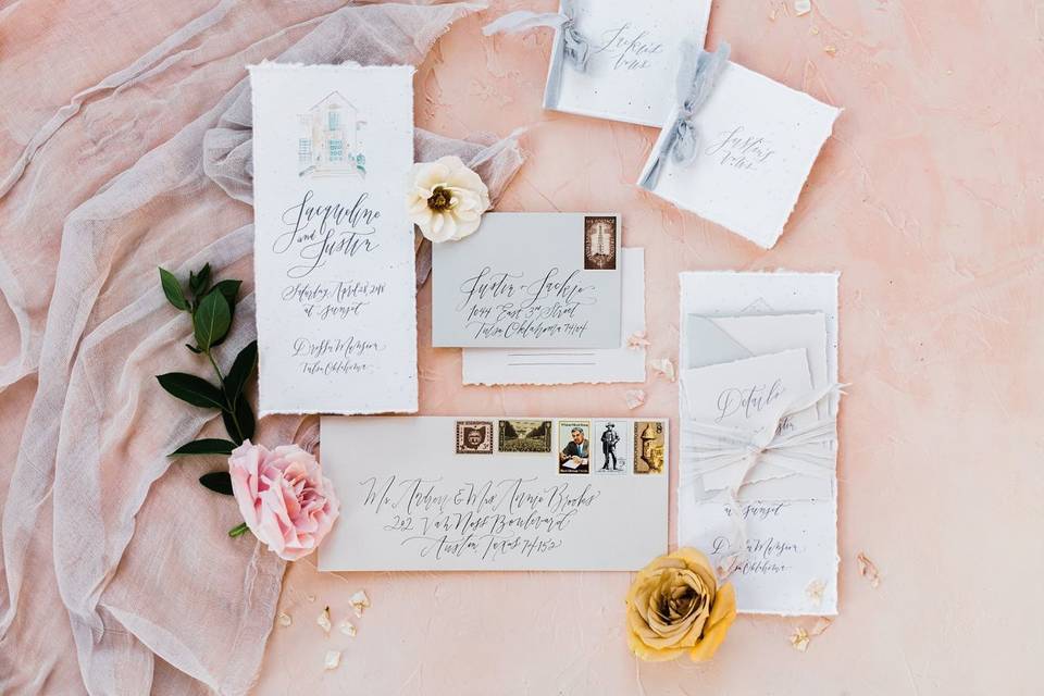 A gorgeous flat lay, featuring Prairie Letter Shop's hand lettered invitation suite and hand painted venue.
