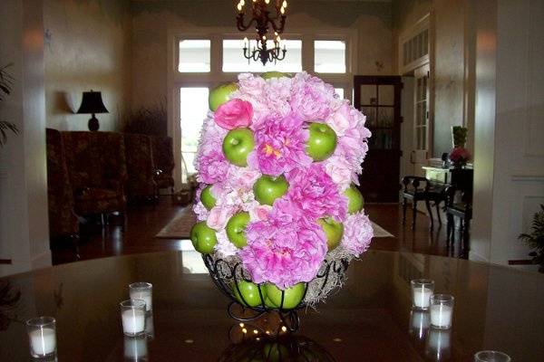 Floral arrangement for foyer table at Berkley Hall CC.  Designed with peonies, garden and sweet heart roses and green apples.