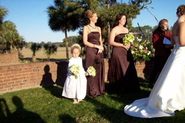 Wedding ceremony on back lawn overlooking marsh at Callawasie Island Country Club.