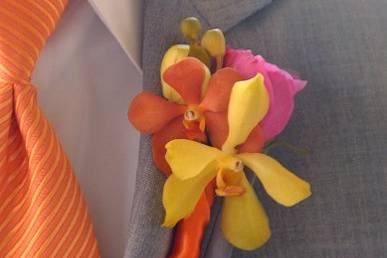 Groom's boutonniere of white calla, dusty miller leaves and blue delphinium.