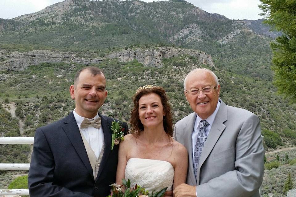 Lovely newlyweds with officiant