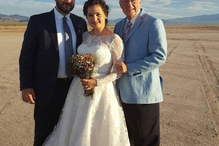 Newlyweds with officiant