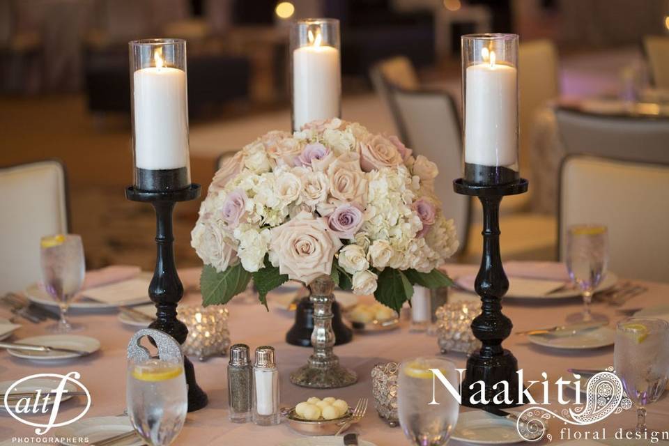 White and pink floral centerpiece and candles