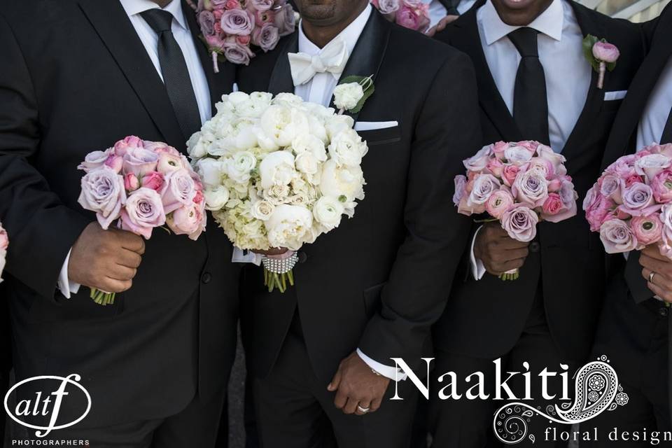 Groom and groomsmen holding the bouquets