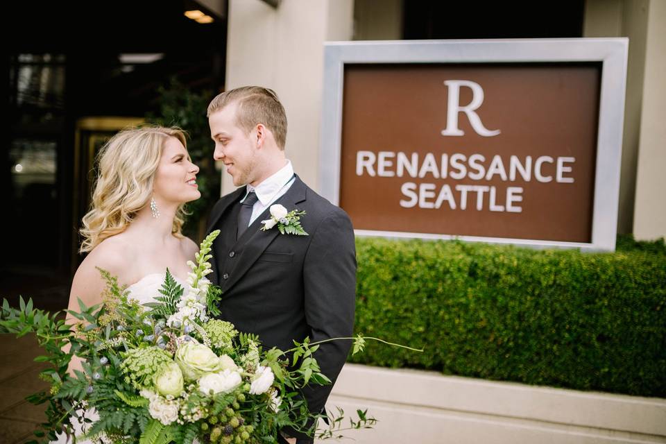 Couple by the sign