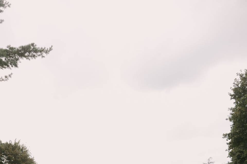 Couple running across lawn