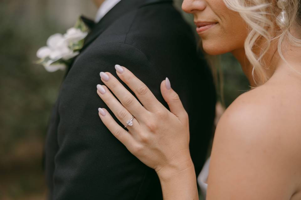 Bride touching grooms arm