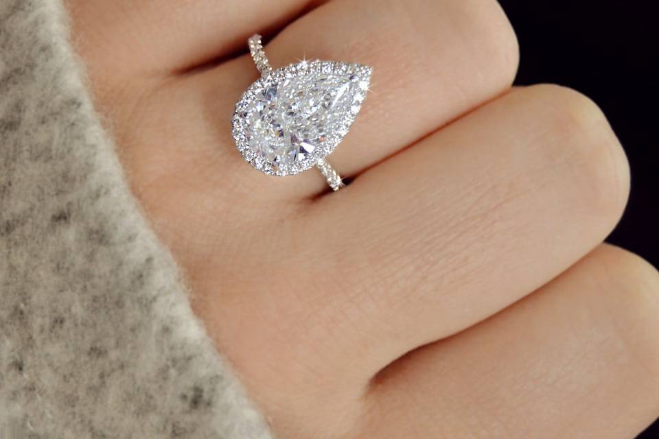 Pear shaped halo diamond engagement ring with a thin band in 18k white gold