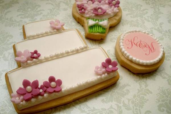 Wedding cake, bouquet, and monogram cookies.
