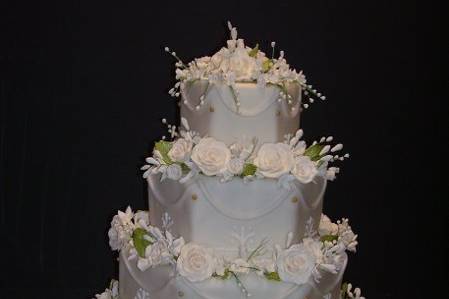 This is a 5 tier stacked cake with Gumpaste Pearl Roses.