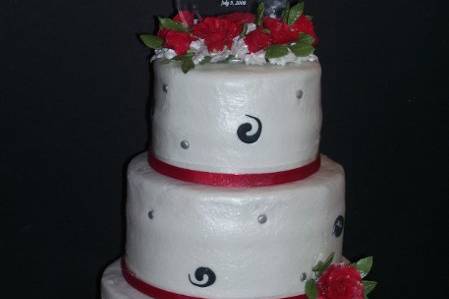 White Buttercream cake with Black Swirls, Silver Dots and Red Gumpaste Roses.