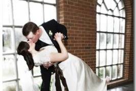 Groom dips and kisses Bride