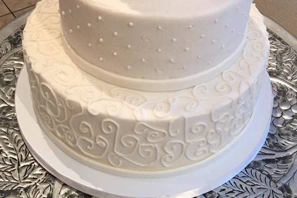 Textured white cake with white rose toppers