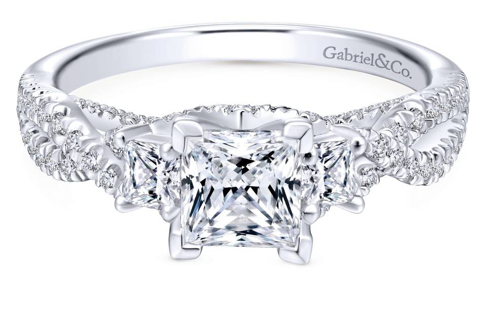 ER12663S3W44JJ	<br>	A criss crossing band of shimmering pave diamonds rises to embrace a pair of sublime princess cut diamonds that will frame your choice of center stone in this stunning three stone engagement ring