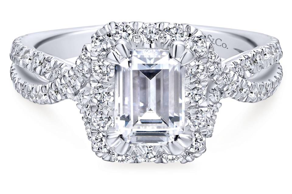 ER12636E4W44JJ	<br>	A luxurious pave diamond halo embraces the emerald cut center stone at the heart of this sensational engagement ring. A criss crossing pave diamond band flows seamlessly toward the center stone.