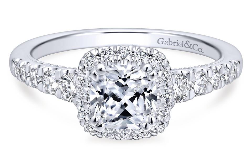 ER12658C4W44JJ	<br>	A softened diamond halo forms a romantic pair with a cushion cut center stone in this timeless engagement ring. A row of carefully selected accent diamonds enhances the white gold band.