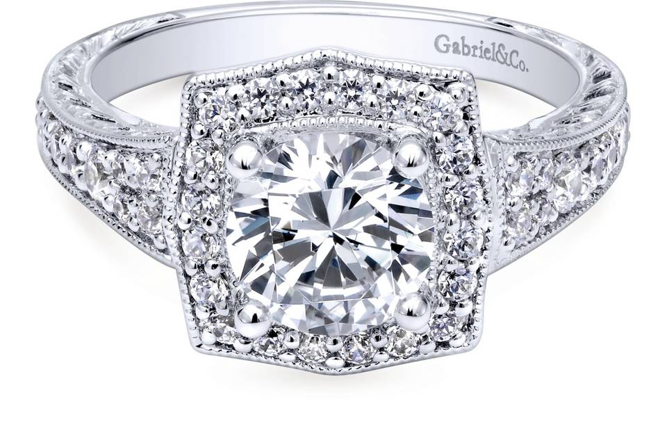 ER10191W44JJ	Exquisitely crafted, this ring portrays a rich, elegant look. Your center stone is caressed by a luminous halo setting and glamourous setting while sitting atop a surprise diamond bridge.