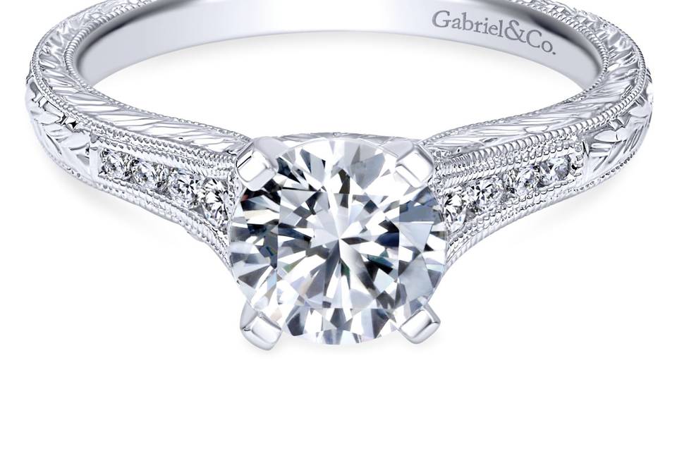 ER10276W44JJ	Hand cut etching and diamond filled channels decorate Gabriel & Co.'s exquisite band to create this vintage engagement ring.