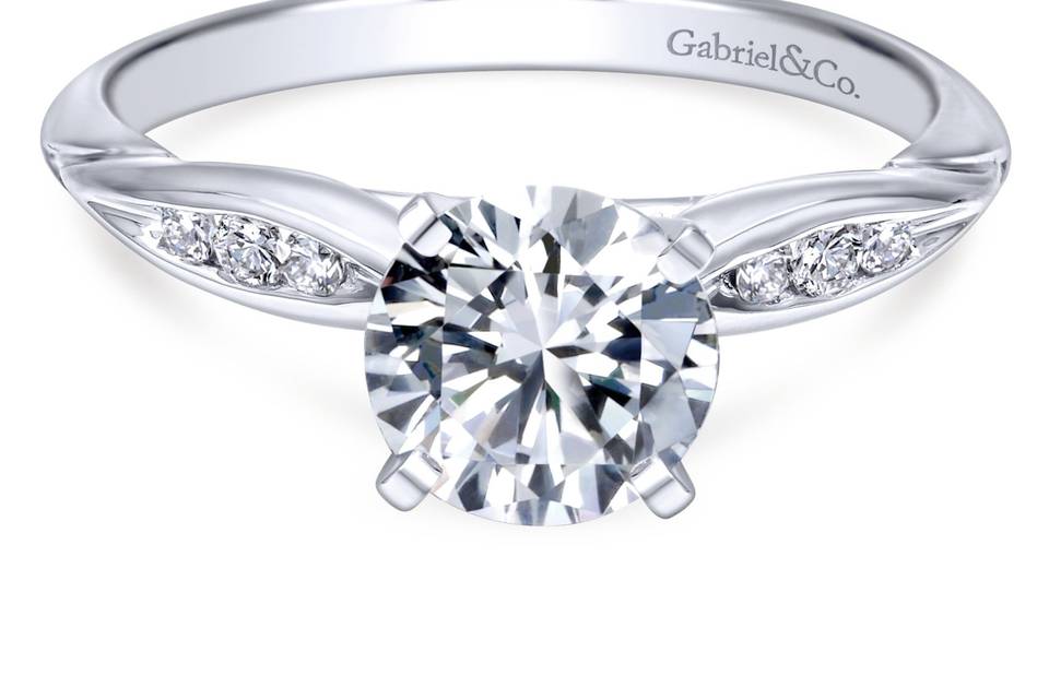 ER11749R3W44JJ	Gabriel & Co.'s sleek and sophisticated ring is straight styled for the classic woman. Showcasing your center stone with delicate oval channels on each side.