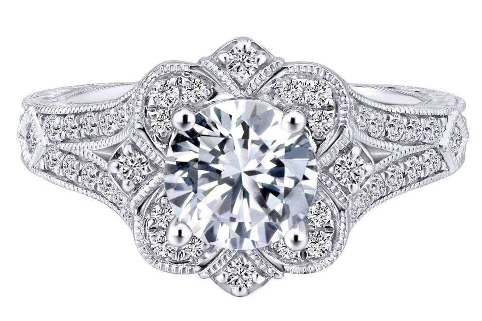 ER11963W44JJ	A floral setting is the base of this Victorian themed 14k white gold engagement ring paired with its diamond shank and hand cut etching.