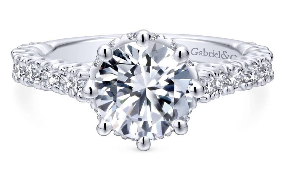 ER12753R6W44JJ	Regal and intricate, the elegant shank of this white gold engagement ring is stunningly surrounded by a gallery of diamonds and a noble prong setting.