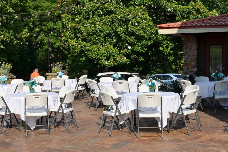 Reception on outdoor patio with overhead twinkle lights.