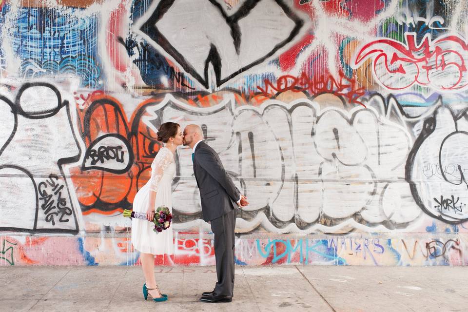 Kissing by the graffiti wall