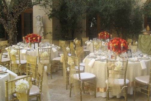 Wedding at the court yard of Ayres hotel with rental provided by Imperial Party Rentas (Gold Chiavari Chairs, Gold Sahses, Ivory linen, Organza embroided overlay, Gold chargers, Ronnel china collection, Gobltes...)