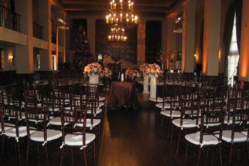 Wedding Ceremony at Wilshire Ebell Theater with rentals provided by Imperial Party Rentals (dark Mahogany chiavari chairs with ivory cushion, Roman Pedestal...)
